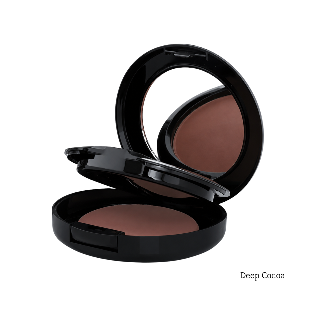 An open black makeup compact showing a deep cocoa brown foundation powder, with a mirror visible in the lid, on a white background with the text 'Deep Cocoa' in the bottom right corner.