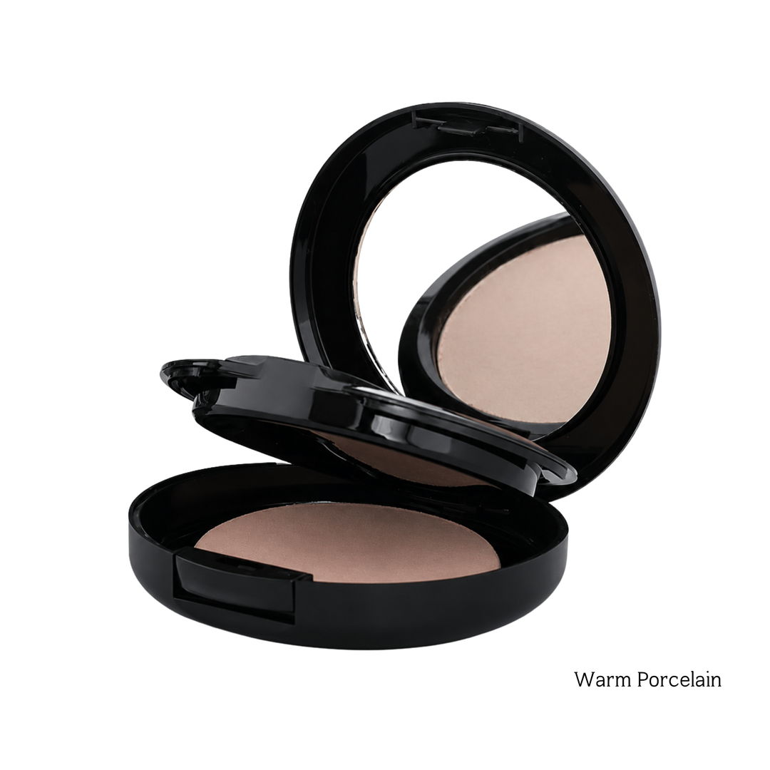 An open black makeup compact showing a warm beige pressed powder with a mirror in the lid, labeled 'Warm Porcelain' on a white background.
