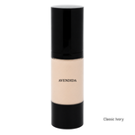Load image into Gallery viewer, A bottle of Avendida Classic Ivory liquid foundation with a black cap and base, showing the beige foundation inside, on a white background with 'Soft Ivory' text in the bottom right corner.