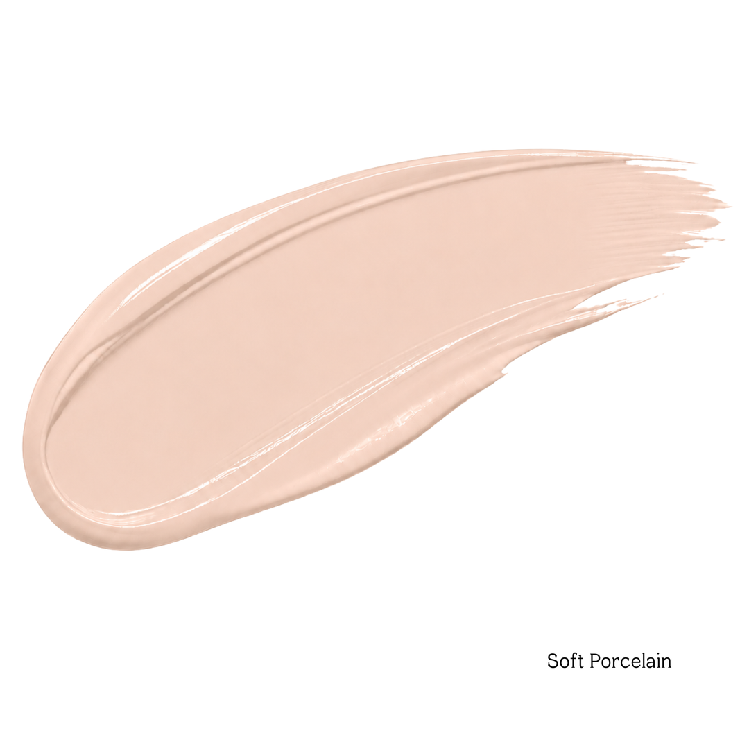 A swatch of liquid foundation or concealer in the shade 'Soft Porcelain' is shown as a smooth, glossy swipe on a plain white background with the shade name printed in the bottom right corner.