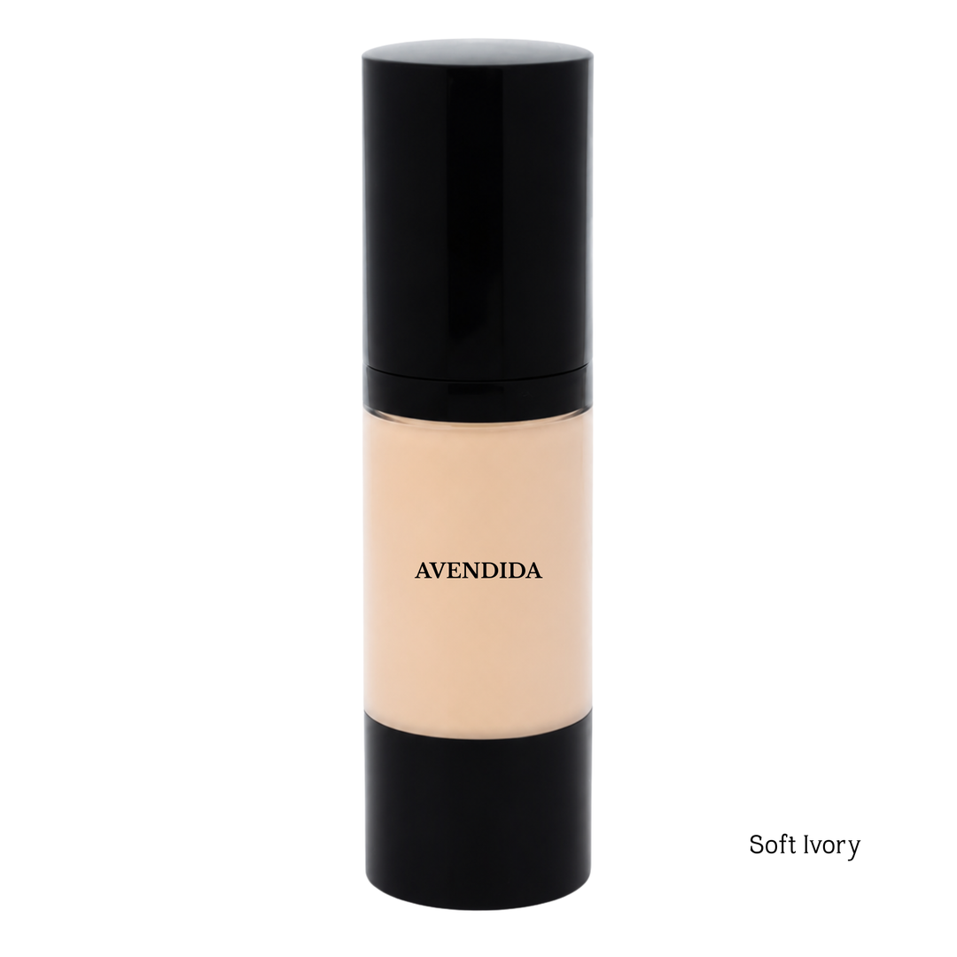 A bottle of Avendida Soft Ivory liquid foundation with a black cap and base, showing the beige foundation inside, on a white background with 'Soft Ivory' text in the bottom right corner.
