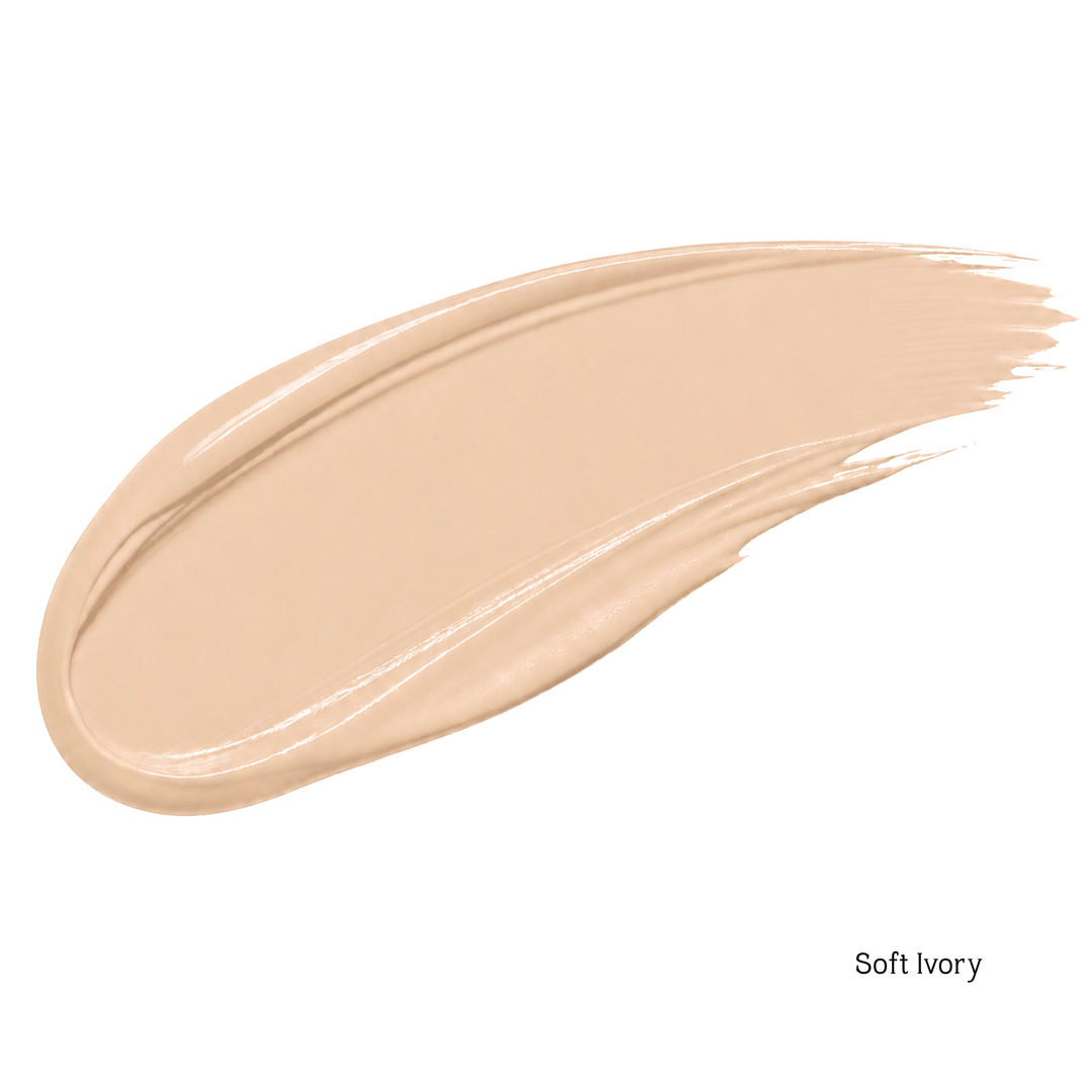 A swatch of liquid foundation in the shade 'Soft Ivory' is shown as a smooth, glossy diagonal smear on a plain white background.
