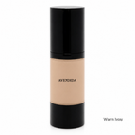 Load image into Gallery viewer, A bottle of AVENDIDA liquid foundation in the shade Warm Ivory, featuring a glossy black cap and base with a beige-toned center showing the liquid makeup. The brand name 'AVENDIDA' is printed in black on the beige section, and 'Warm Ivory' is written in small text in the bottom right corner against a solid white background.