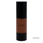 Load image into Gallery viewer, A bottle of AVENDIDA liquid foundation in the shade Deep Walnut, featuring a deep brown liquid visible through a clear cylindrical bottle with a glossy black cap and base, set against a plain white background.