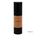 Load image into Gallery viewer, A bottle of AVENDIDA liquid foundation in the shade Golden Tan, featuring a glossy black cap and base with a clear center showing the warm golden-tan liquid. The shade name 'Golden Tan' is printed in black text in the bottom right corner against a solid white background.
