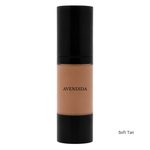 Load image into Gallery viewer, A bottle of AVENDIDA liquid foundation in the shade Soft Tan, featuring a black cap and base with the beige-tan liquid visible in the center, set against a plain white background.